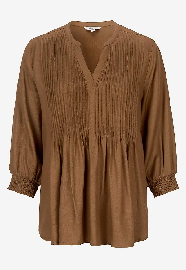 Blus med sydda veck