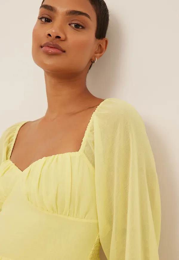 NA-KD Boho Miniklänning med volangdetalj - Yellow