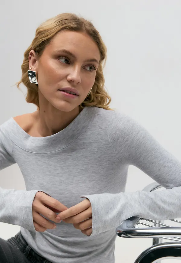 Sloped shoulder top
