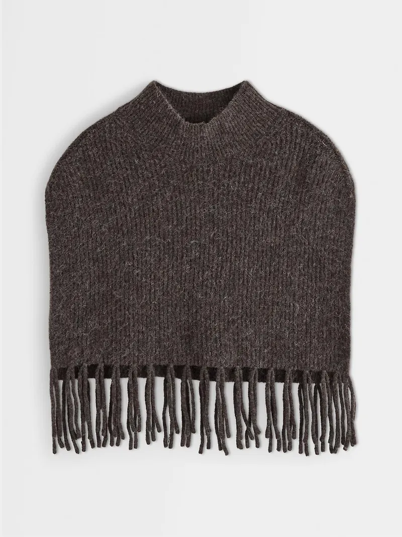 Stickad poncho med fransar